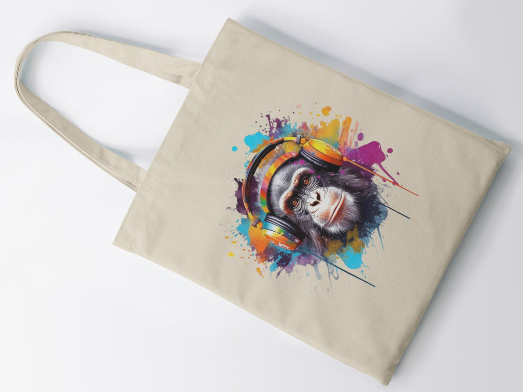 Beige tote bag with a colorful monkey design wearing headphones on a white background