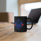 Black mug with blue text on a wooden surface