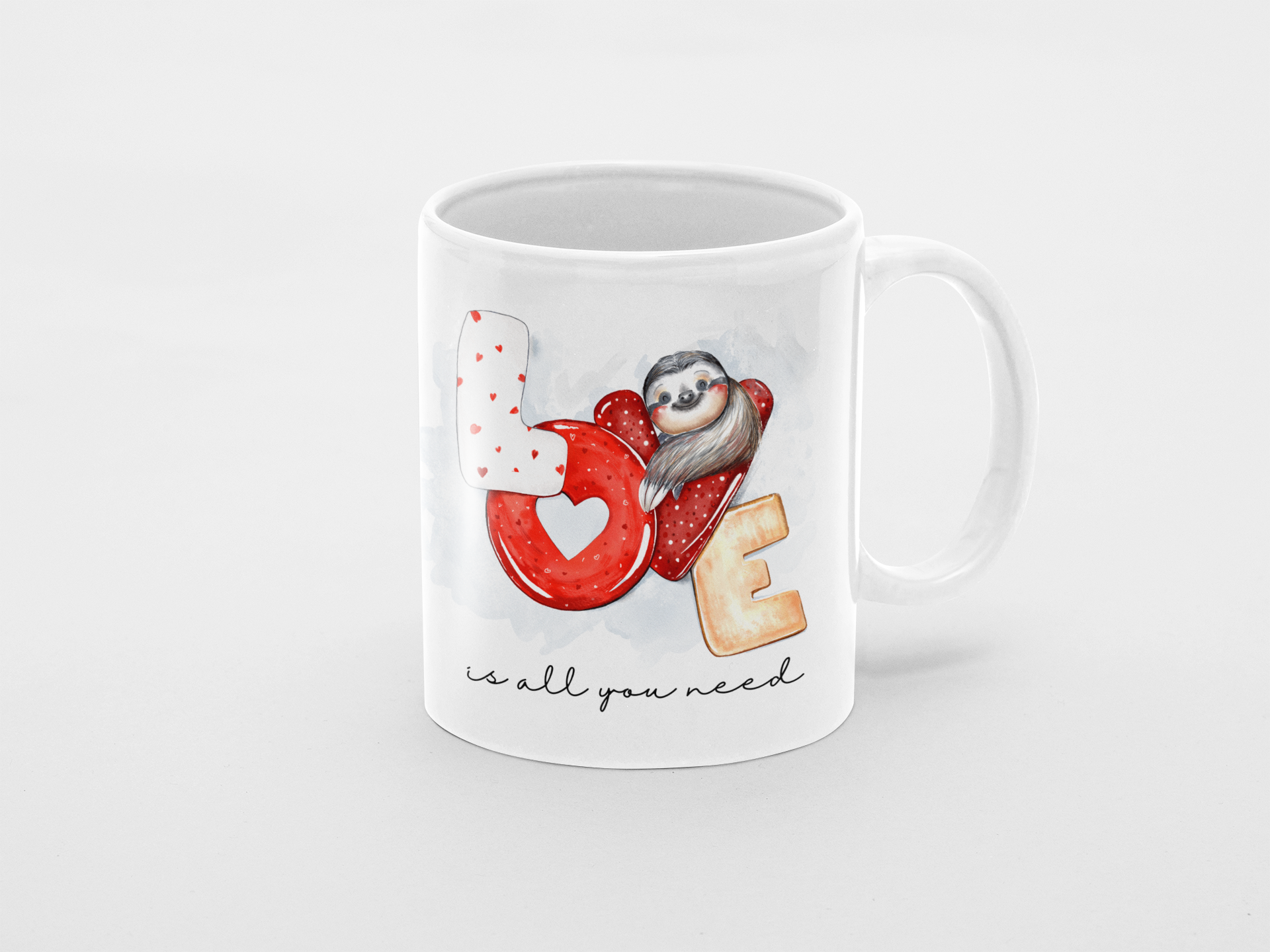 Mug with sloth illustration and 'LOVE is all you need' text on a white background