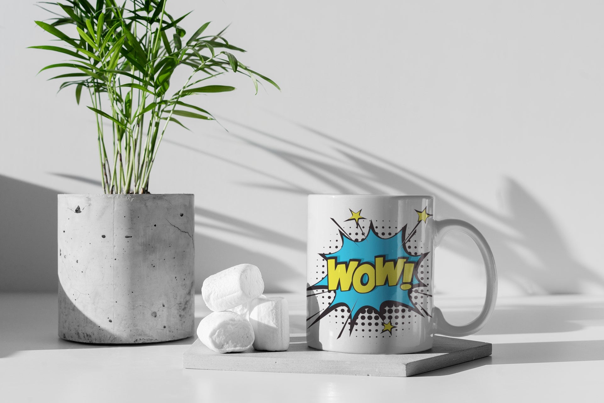 Mug with 'Wow' design next to a plant on a light surface