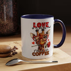 Mug with giraffe design and text 'Love is in the air and it smells like coffee' on a wooden surface with coffee beans and a spoon.
