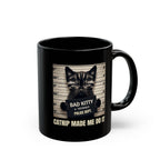 Black mug with a cat graphic and text on a white background
