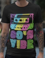 Black t-shirt with a colorful cassette tape design and '80's Vibe' text.