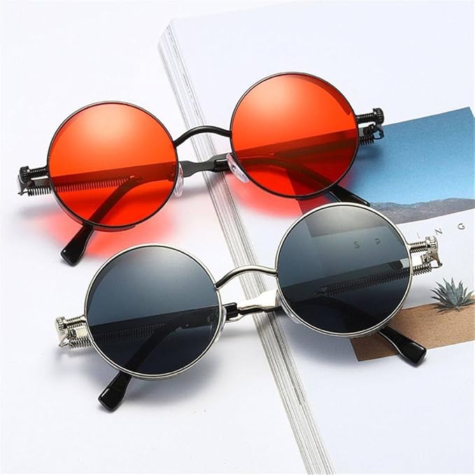 Two pairs of round sunglasses with red and black frames on a magazine background