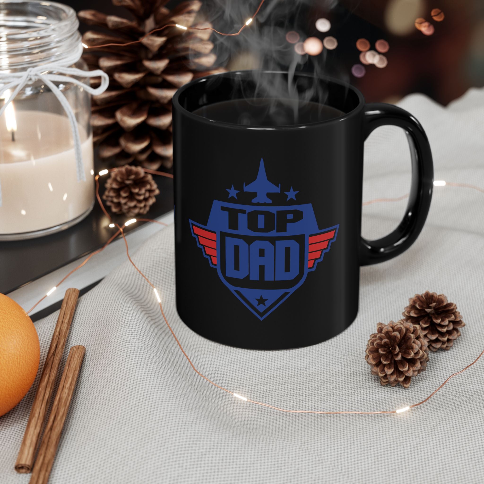 Black mug with 'Top Dad' design on a table with decorative items