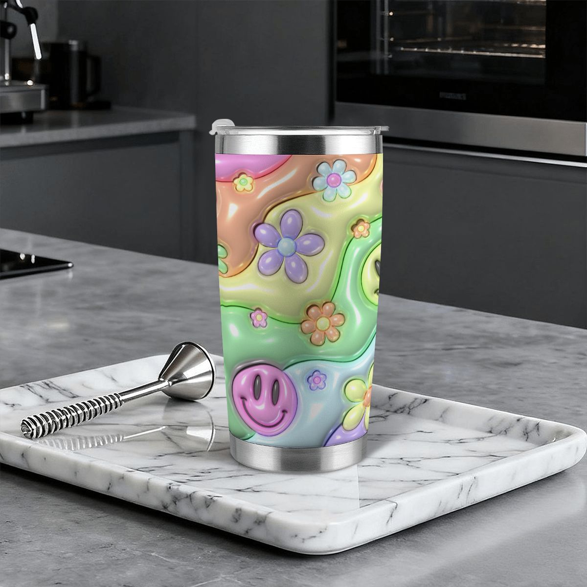 Colorful tumbler with floral design on a marble tray in a kitchen setting