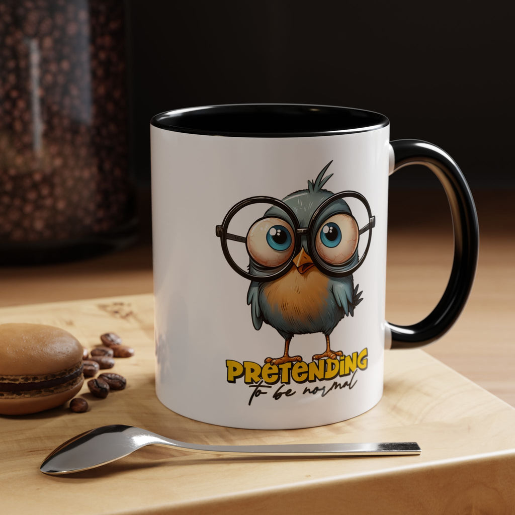Mug with cartoon owl design and text on a wooden surface with coffee beans and a macaron.