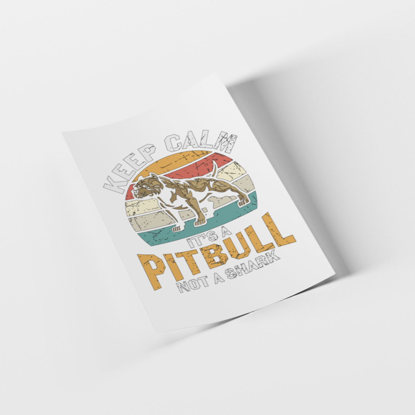A printed poster or art print shown at an angle on a light gray background. The design features a pitbull illustration over a retro sunset and map-style graphic with the text 'KEEP CALM IT'S A PITBULL NOT A SHARK'.