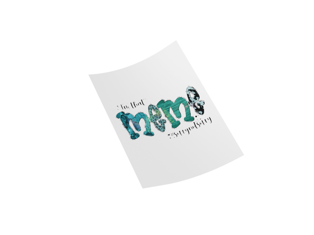 A white rectangular card or sticker shown at an angle on a black background, featuring the phrase "in that mama'ssyndrome" in black script with the word "mama" filled with a teal and black marbled pattern.