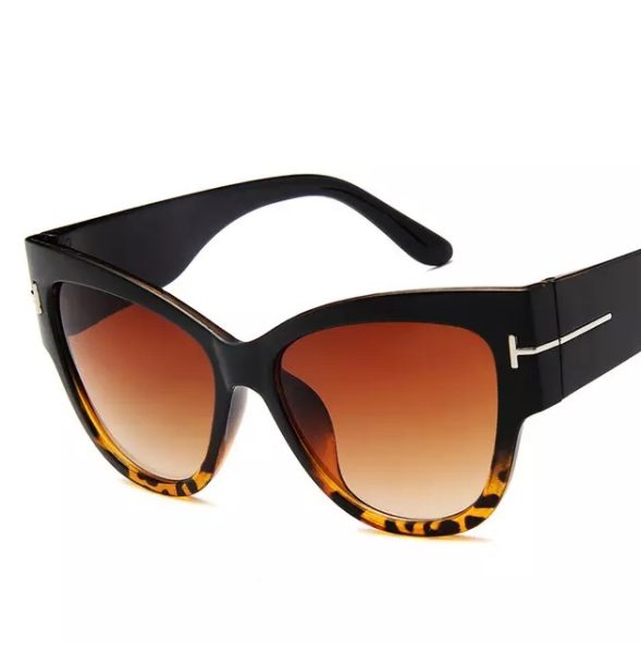 Black and tortoiseshell sunglasses with brown lenses on a white background