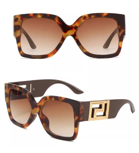 Tortoiseshell sunglasses with a gold logo on a white background