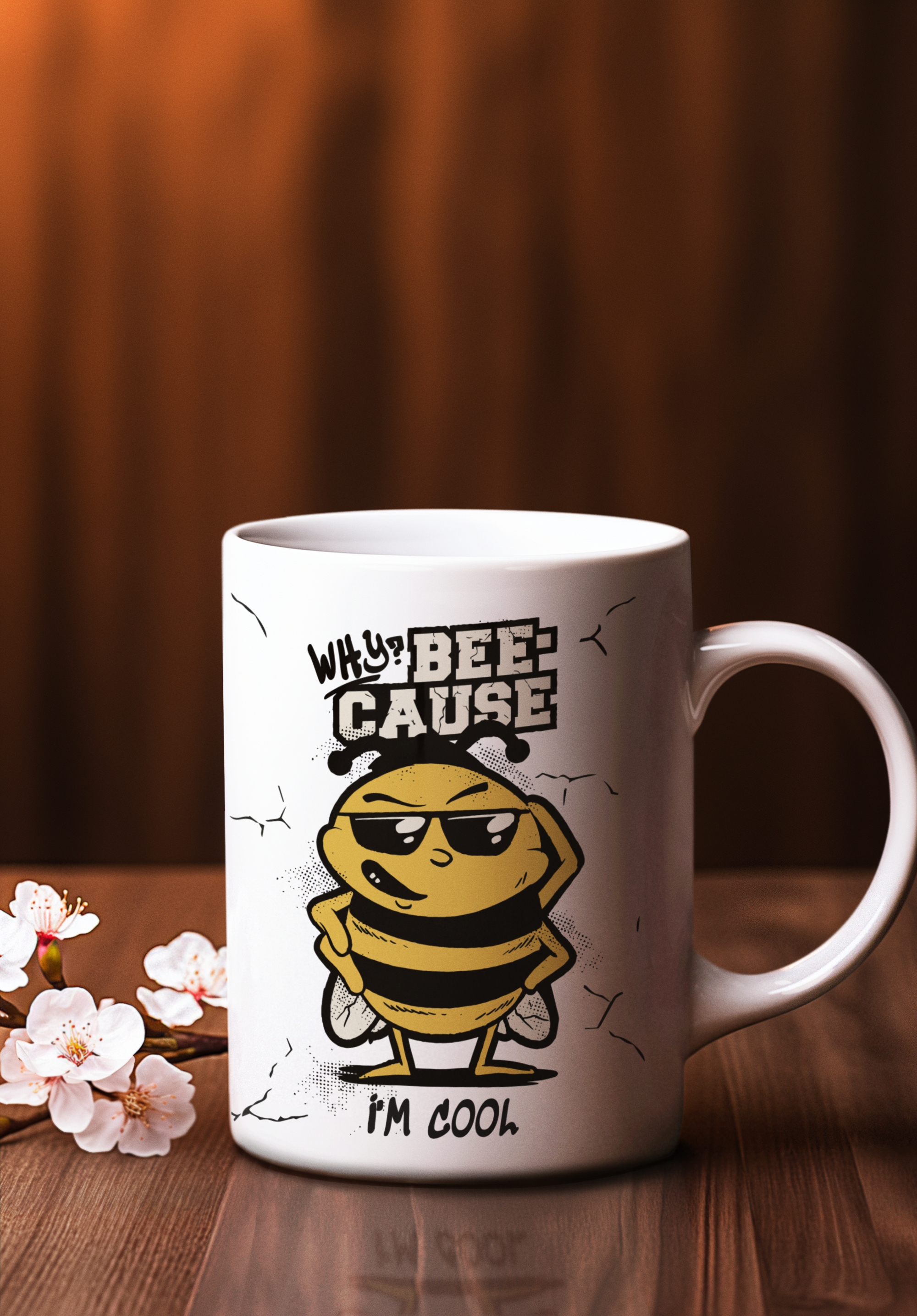 A white ceramic coffee mug with a cartoon bee wearing sunglasses and the text 'WHY? BEE CAUSE I'M COOL' printed on the side, set on a wooden table with cherry blossoms and a warm brown background.