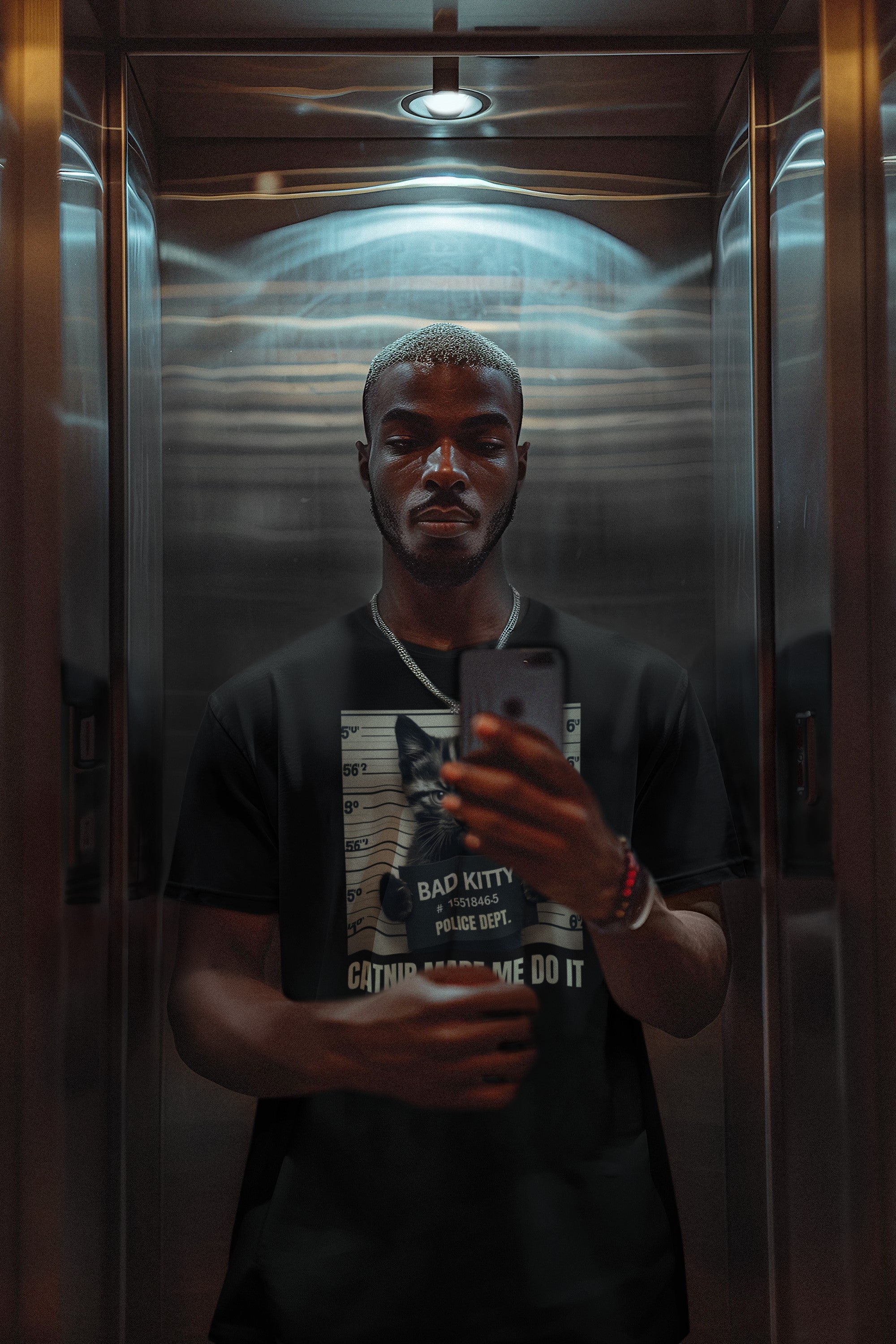 Man taking a selfie in an elevator with a phone