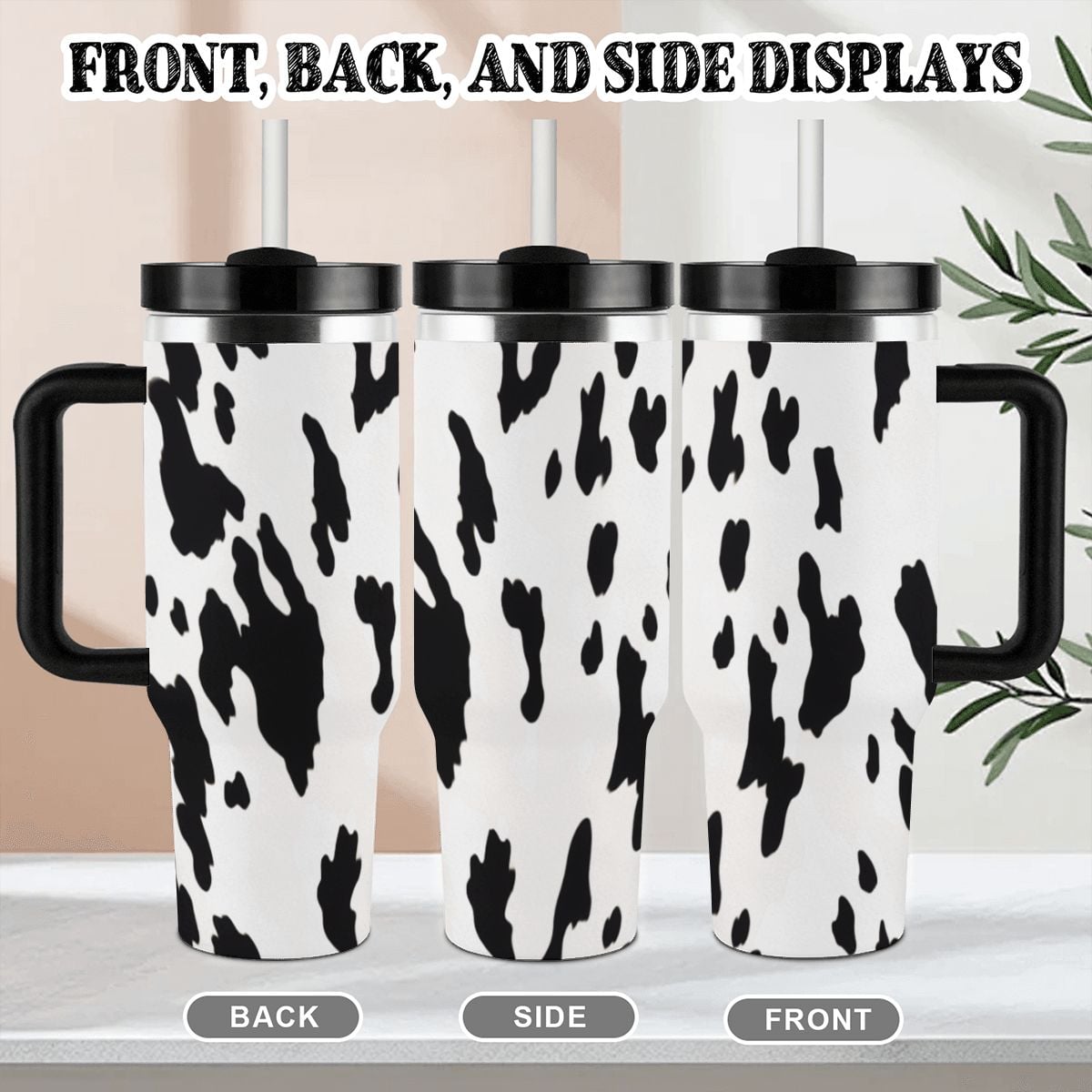 Three cow print travel mugs with black handles shown from front, back, and side views.