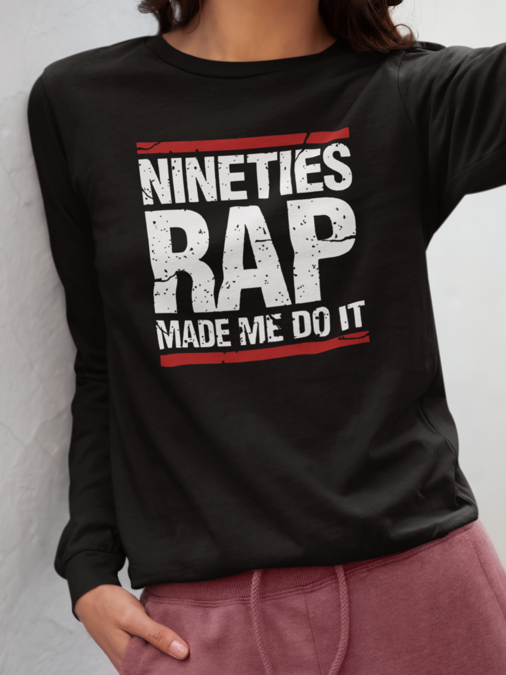 Black sweatshirt with 'Nineties Rap Made Me Do It' text worn by a person.