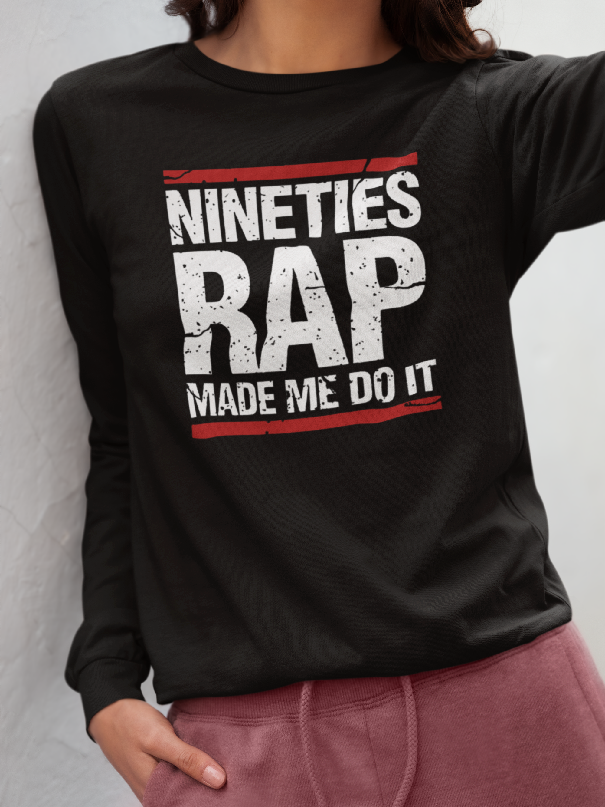 Black sweatshirt with 'Nineties Rap Made Me Do It' text worn by a person.