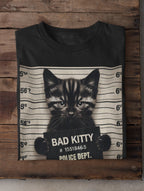 Black t-shirt with a cat mugshot design on a wooden background