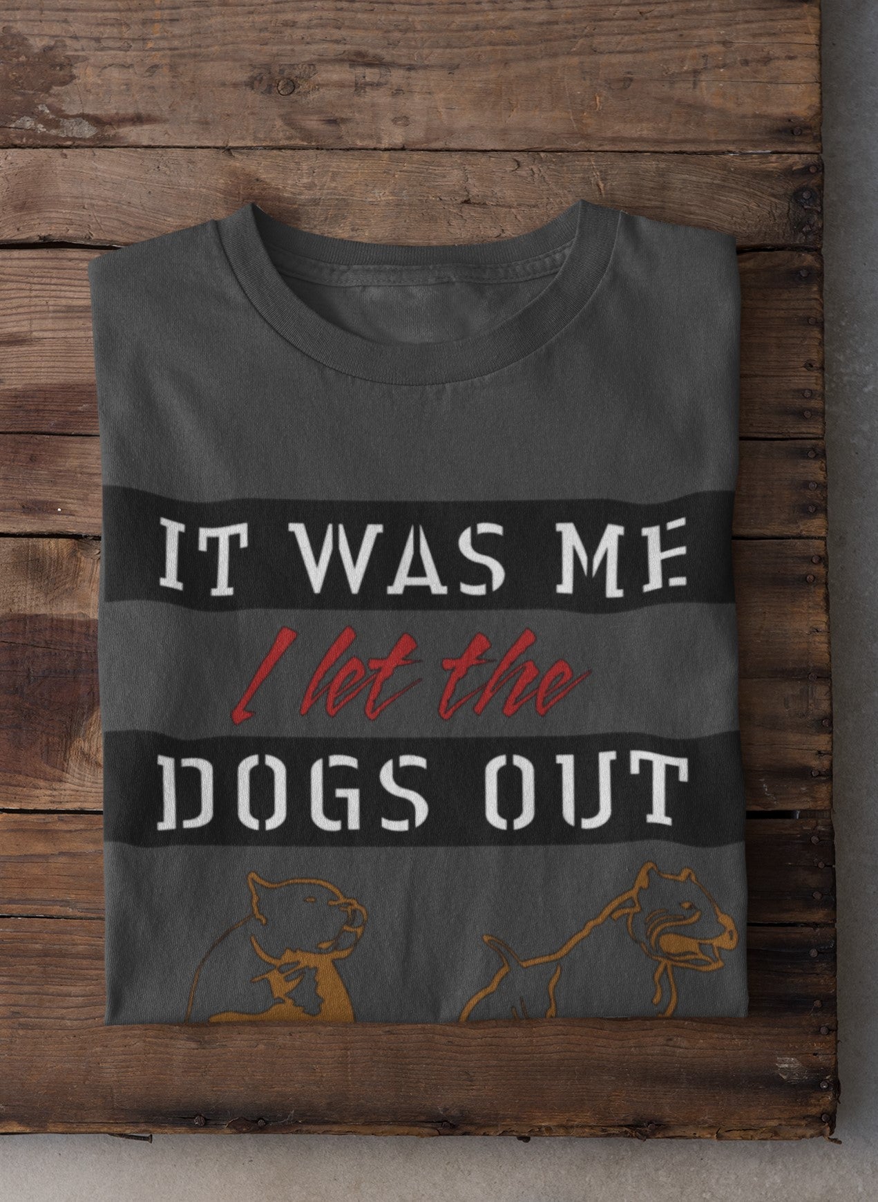 Gray t-shirt with humorous text design on a wooden surface