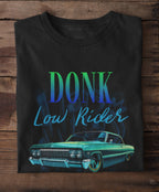 Black t-shirt with 'DONK Low Rider' text and lowrider car graphic on a wooden surface