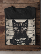 Black t-shirt with a cat mugshot design on a wooden background
