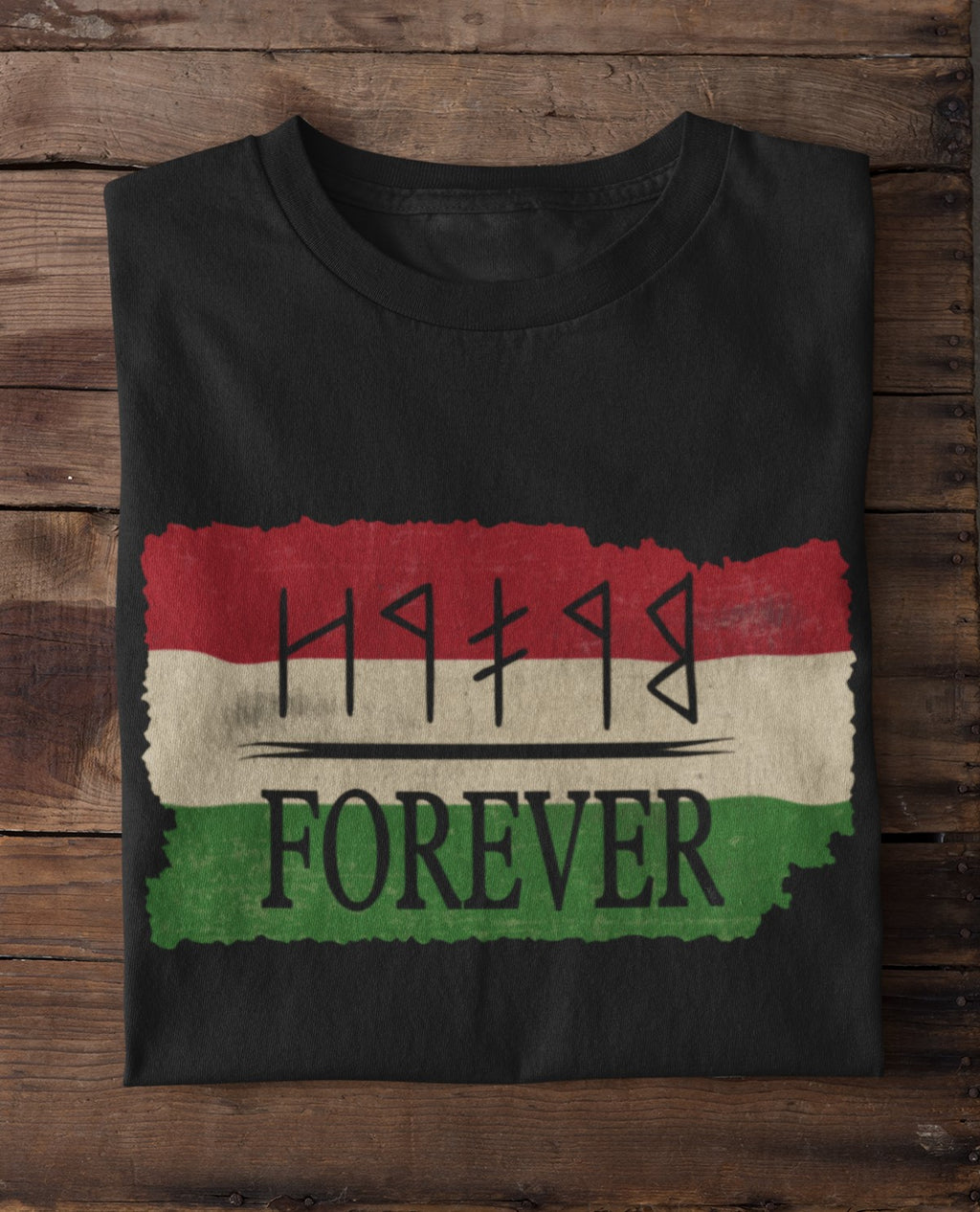 Black t-shirt with a design of red, white, and green colors and text on a wooden surface