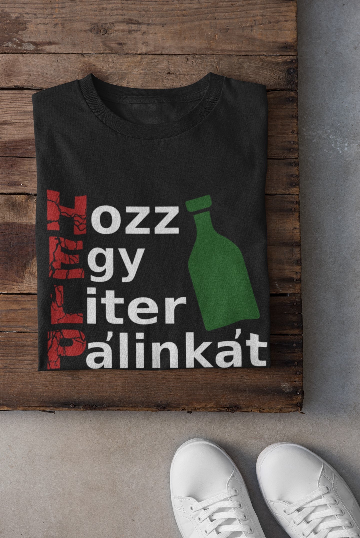 Black t-shirt with text and bottle graphic on a wooden surface