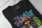 Black t-shirt with colorful graphic design of a bear and text on a white surface