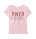 Pink t-shirt with 'ANYA KNOWS' text on a white background