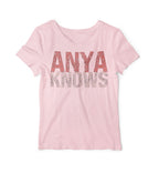 Pink t-shirt with 'ANYA KNOWS' text on a white background