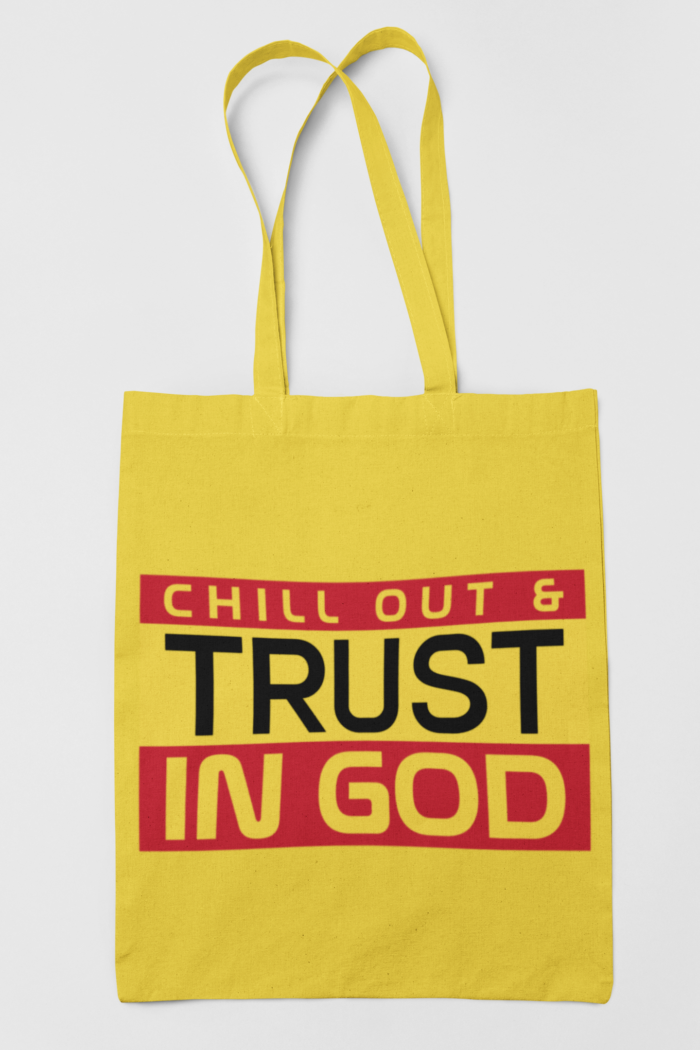 Yellow tote bag with 'Chill Out & Trust In God' text on a white background