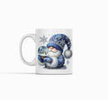White mug with a decorative design of a gnome in a blue outfit and hat on a white background