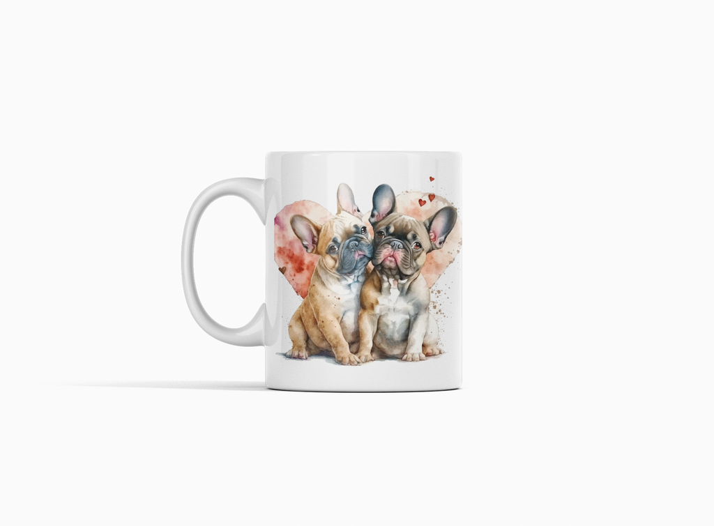A white ceramic mug featuring a watercolor-style illustration of three French bulldog puppies sitting side by side, with a soft pink heart-shaped splash in the background. The mug is photographed on a clean, light gray studio background.