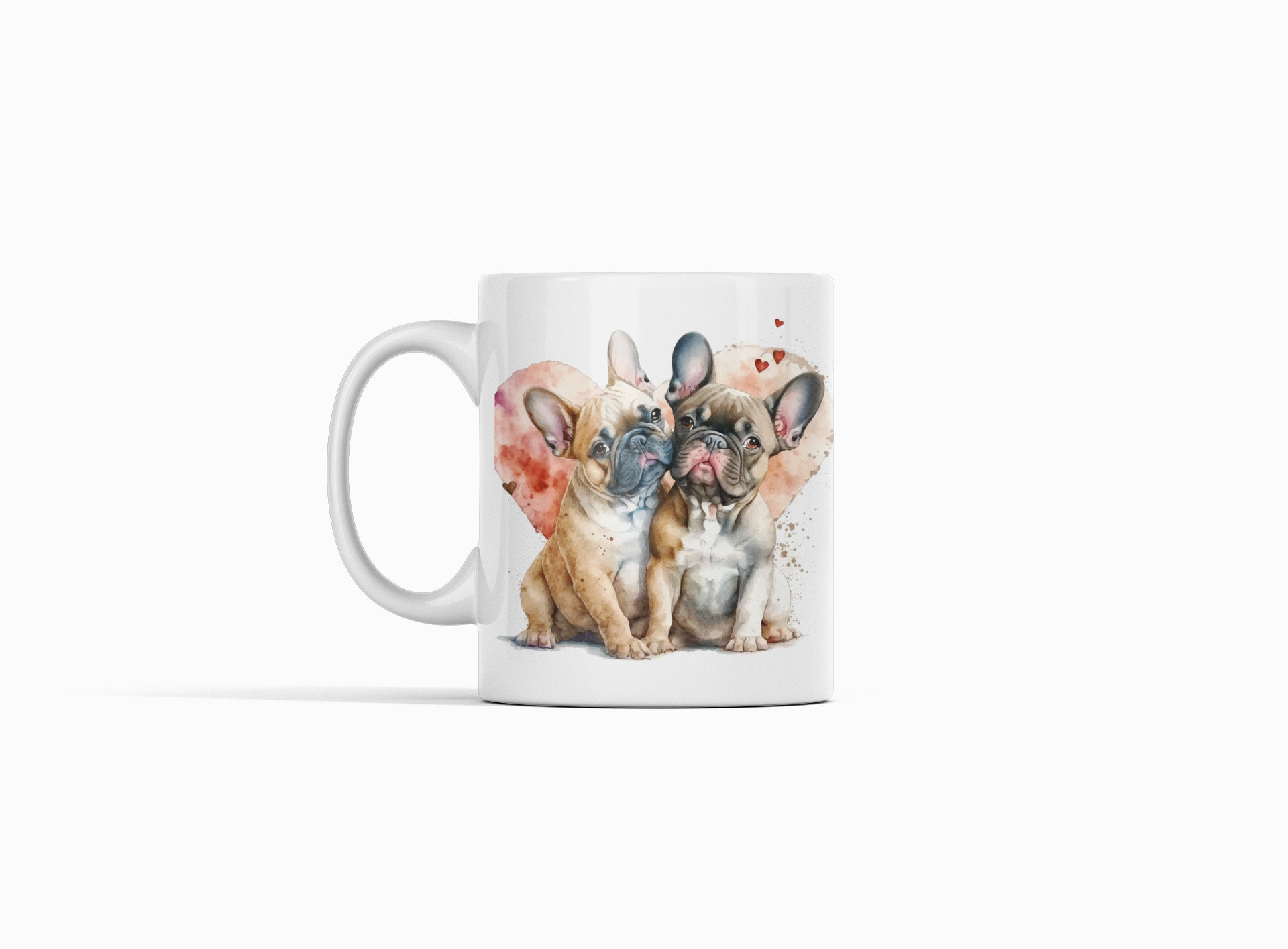 A white ceramic mug featuring a watercolor-style illustration of three French bulldog puppies sitting side by side, with a soft pink heart-shaped splash in the background. The mug is photographed on a clean, light gray studio background.