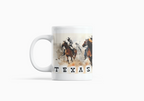 A white ceramic mug featuring a printed graphic of a Western-themed rodeo scene with horses and riders, and the word 'TEXAS' printed below in black block letters.