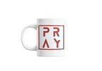 White mug with red 'PRAY' text on a white background
