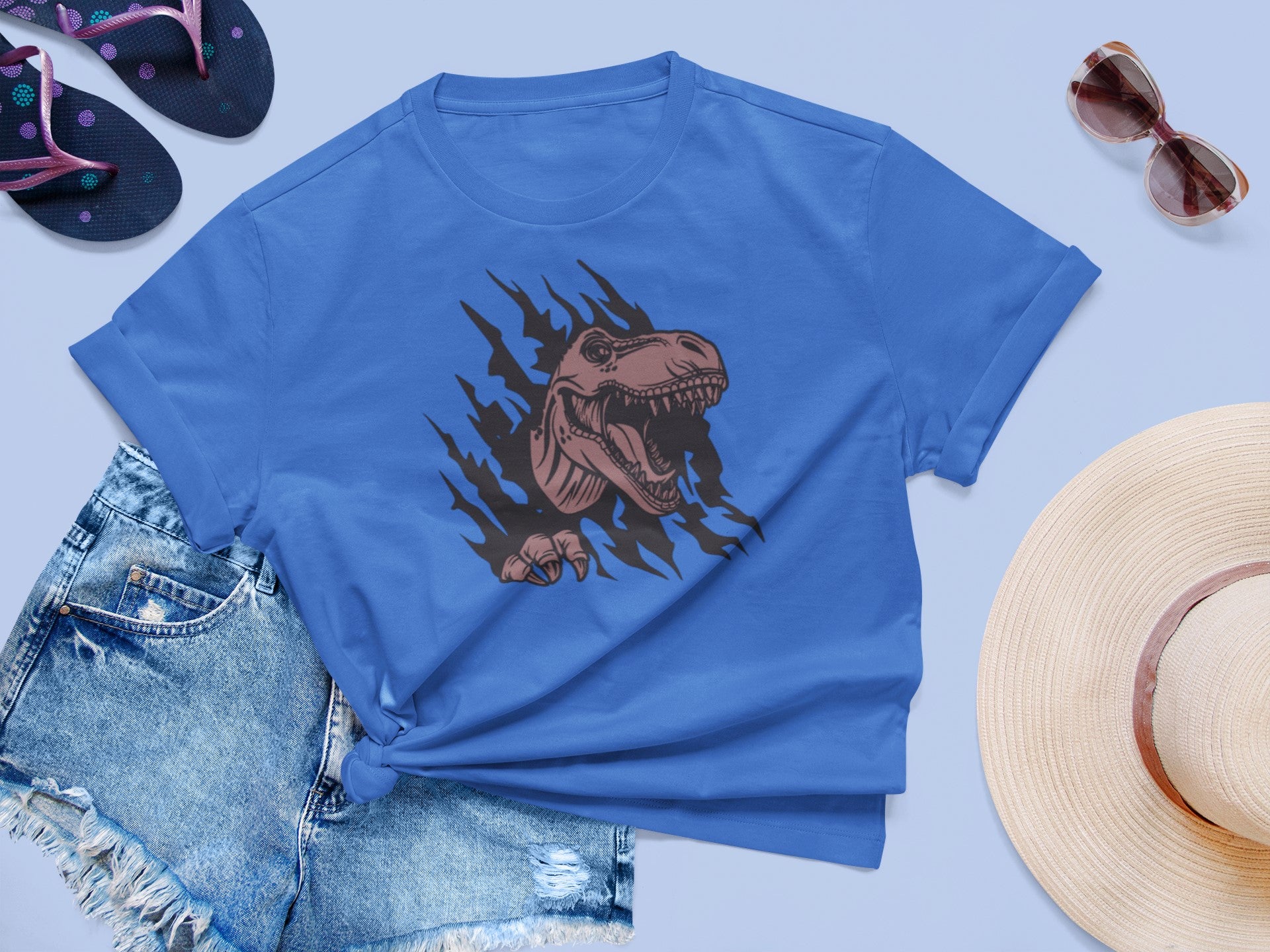 Blue t-shirt with dinosaur graphic on a light blue background
