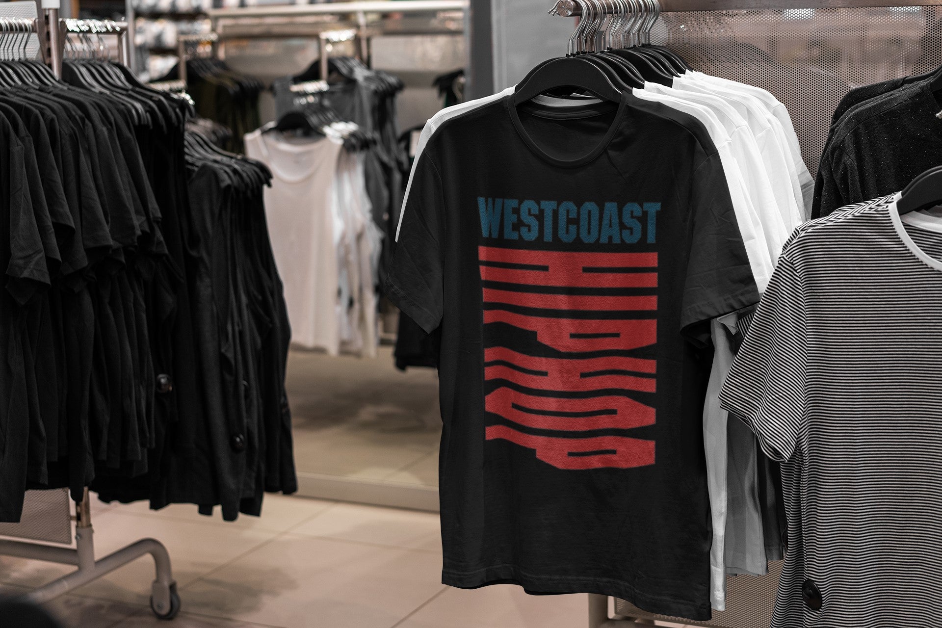 Black t-shirt with 'Westcoast Hip Hop' design hanging on a rack in a store.