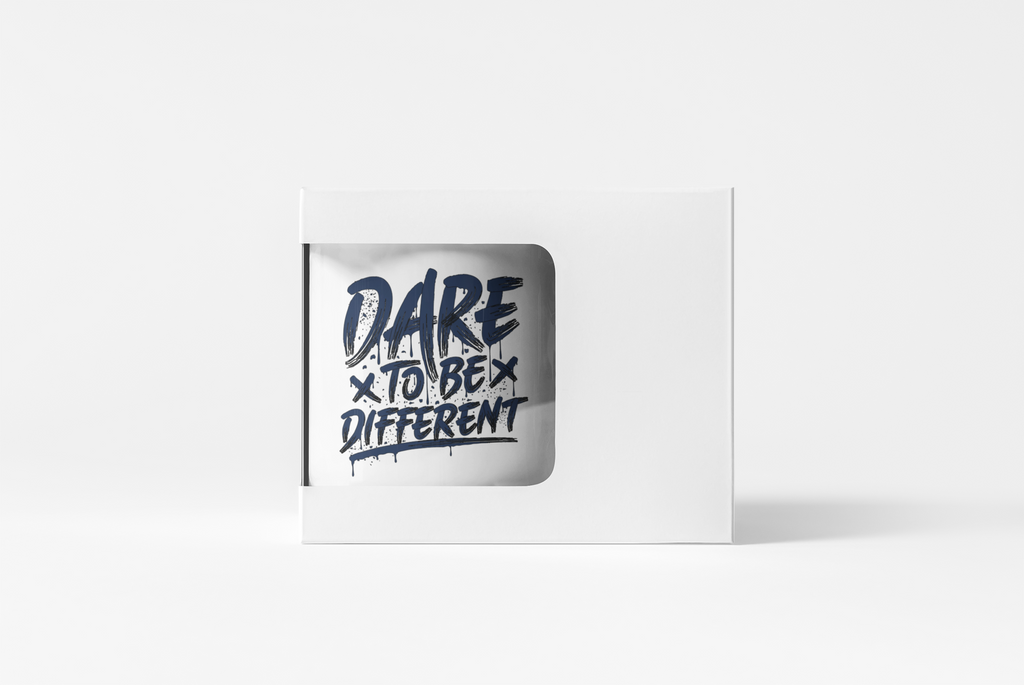 A white rectangular product box with a die-cut window showing a silver mug printed with the phrase 'DARE x TO BE x DIFFERENT' in dark blue lettering, set against a clean white background.