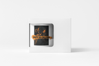 A white square product box with a die-cut window displaying a black square item featuring an orange graphic and the text 'DUTY IS CALLING'.