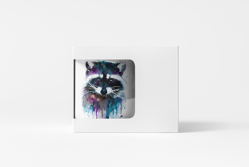 A white rectangular product box with a die-cut window displaying a colorful watercolor raccoon illustration, set against a clean white background.