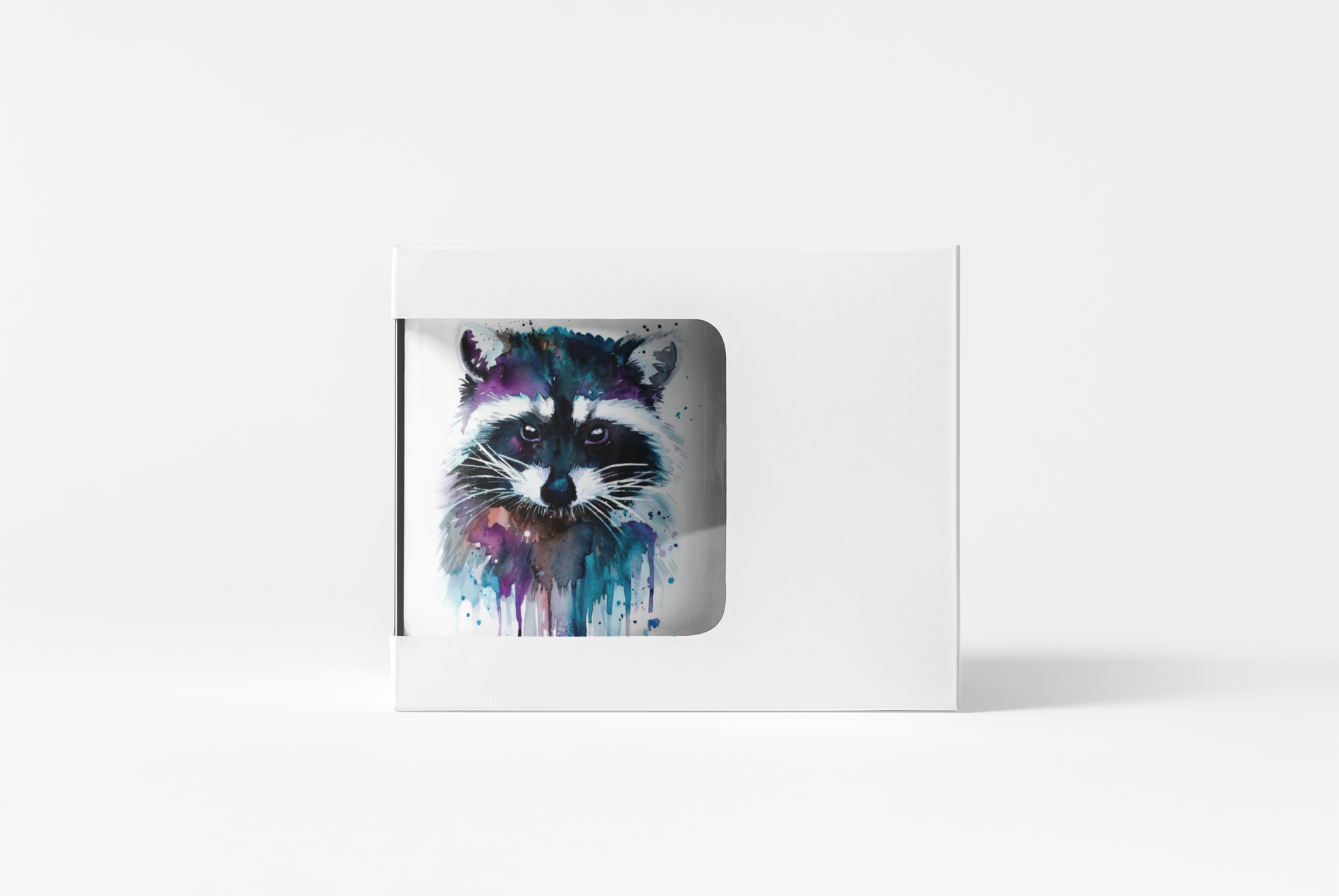 A white rectangular product box with a die-cut window displaying a colorful watercolor raccoon illustration, set against a clean white background.
