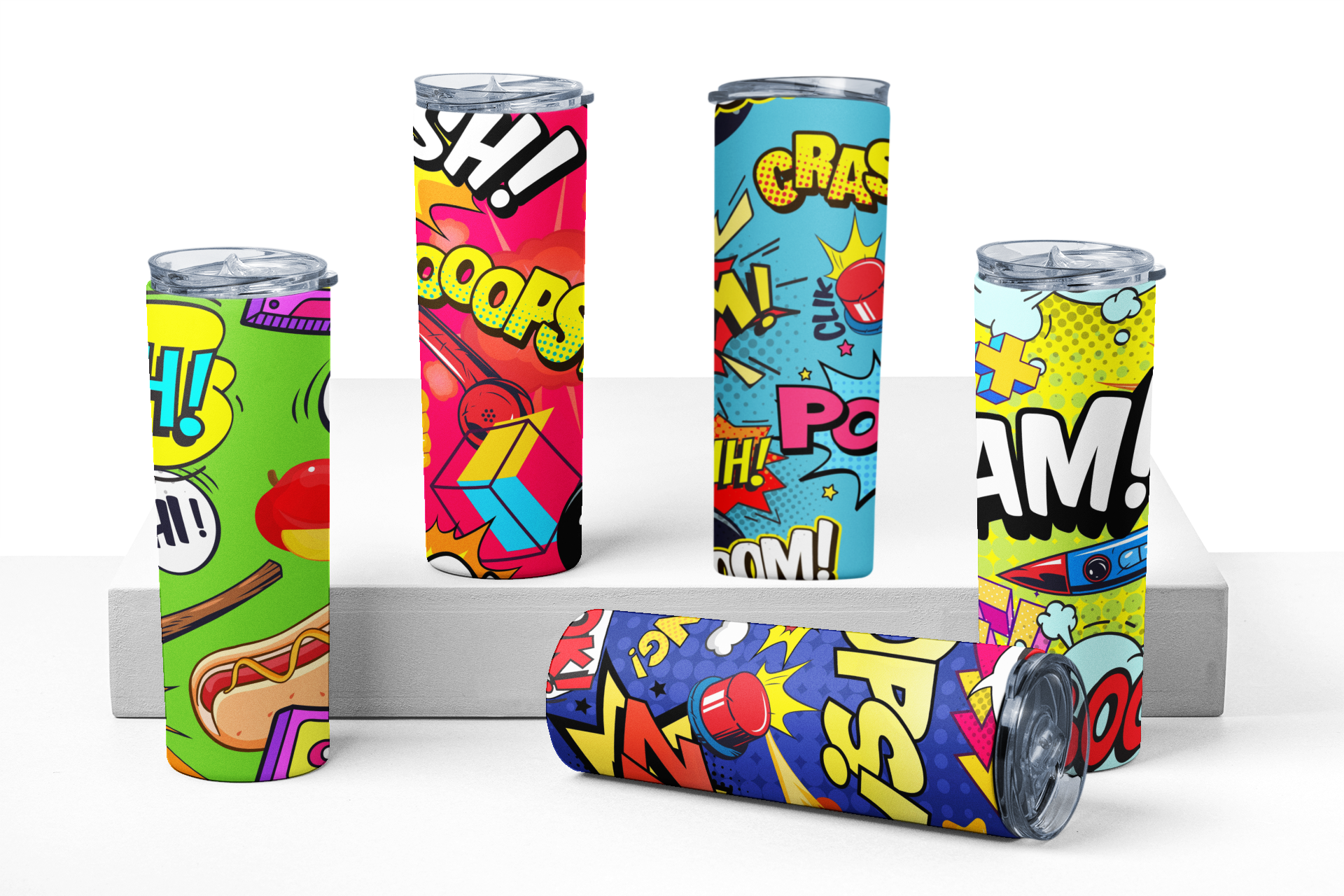 Five colorful tumblers with comic book-style designs on a white background