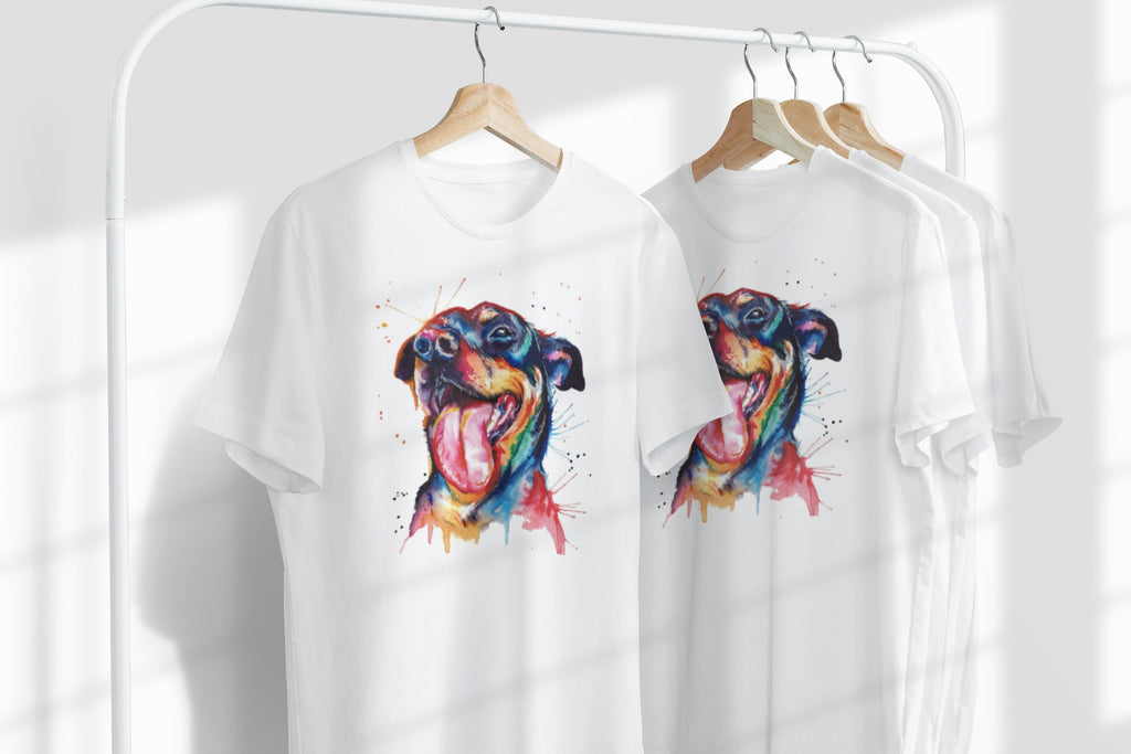 Two white t-shirts with colorful dog illustrations on hangers against a white background