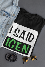Black t-shirt with 'I SAID IGEN' text, denim jacket, sunglasses, and beads on a gray surface