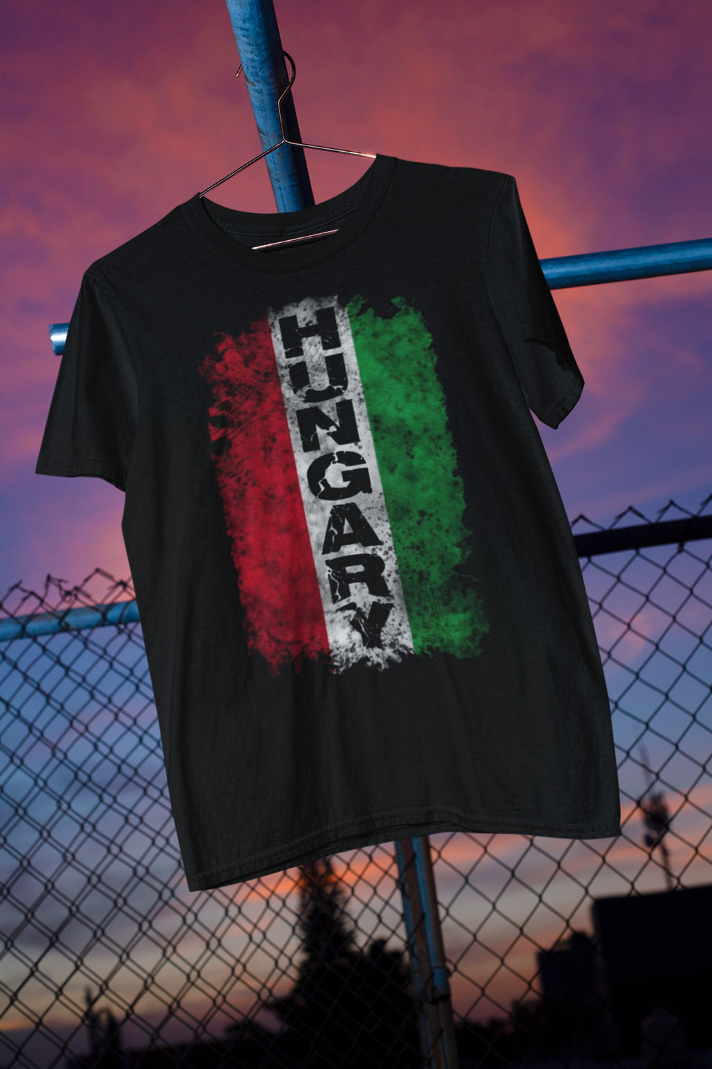 Black t-shirt with 'HungARY' design on a hanger against a sunset sky.