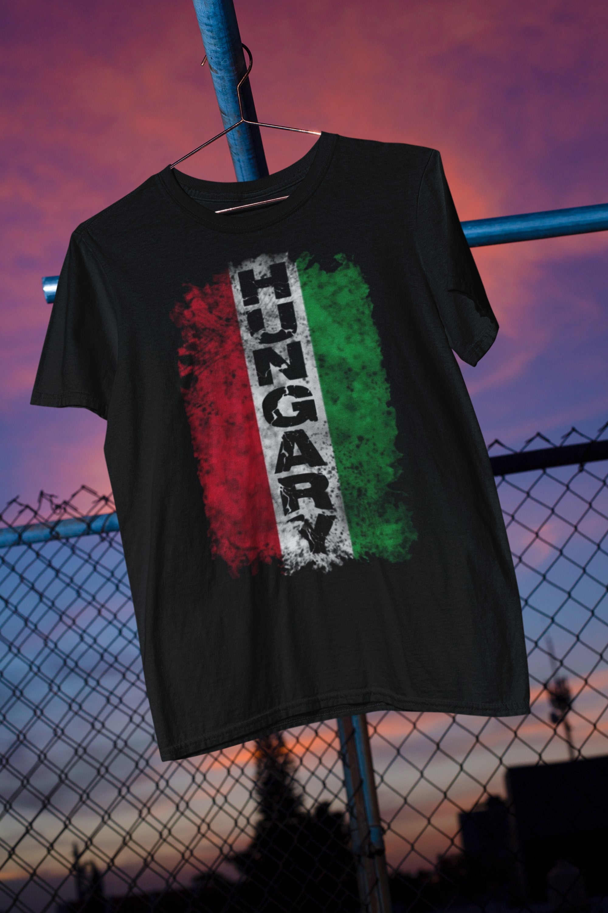 Black t-shirt with 'HungARY' design on a hanger against a sunset sky.