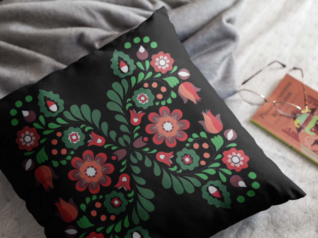 Decorative pillow with floral pattern on a bed