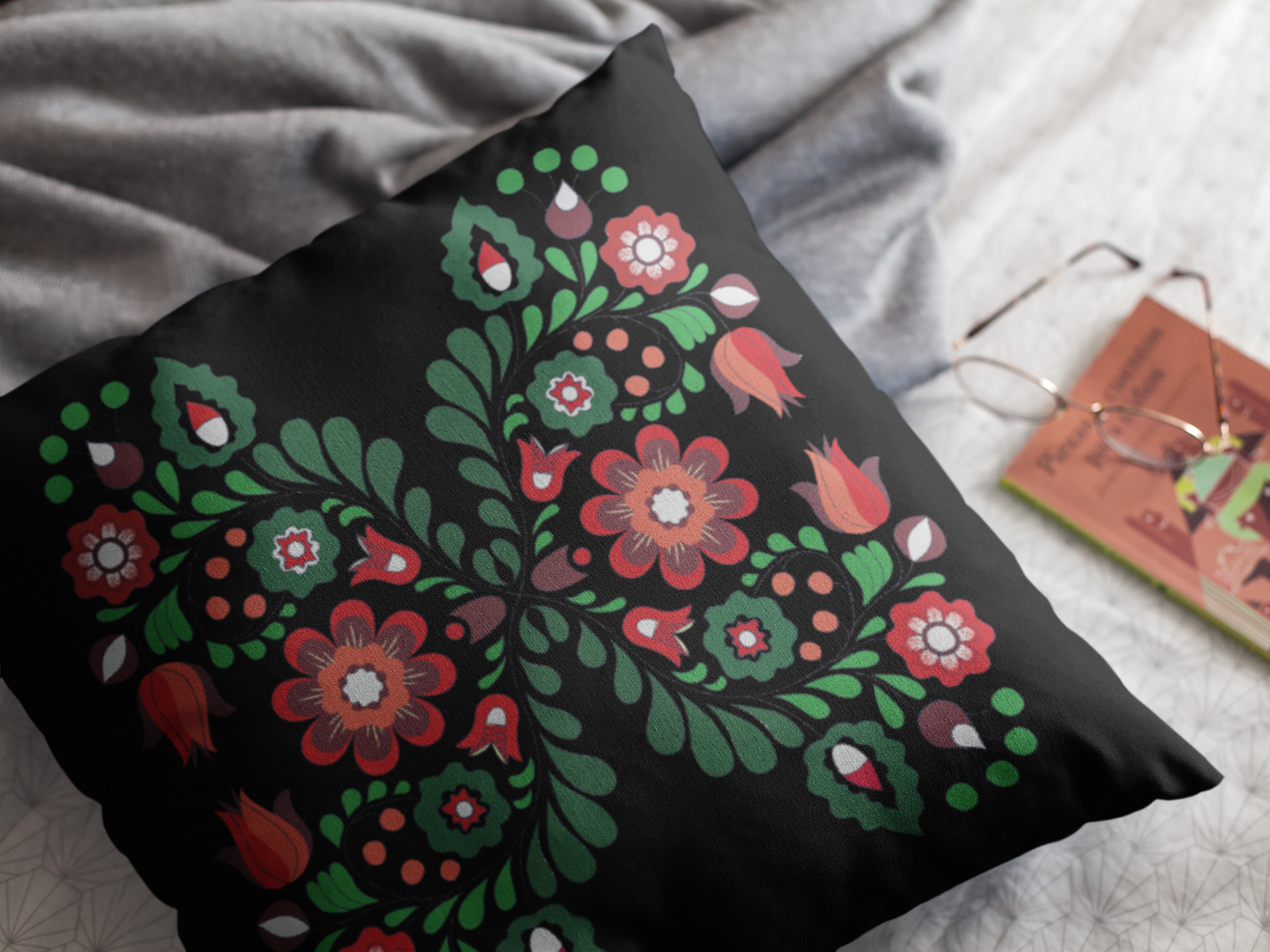 Decorative pillow with floral pattern on a bed