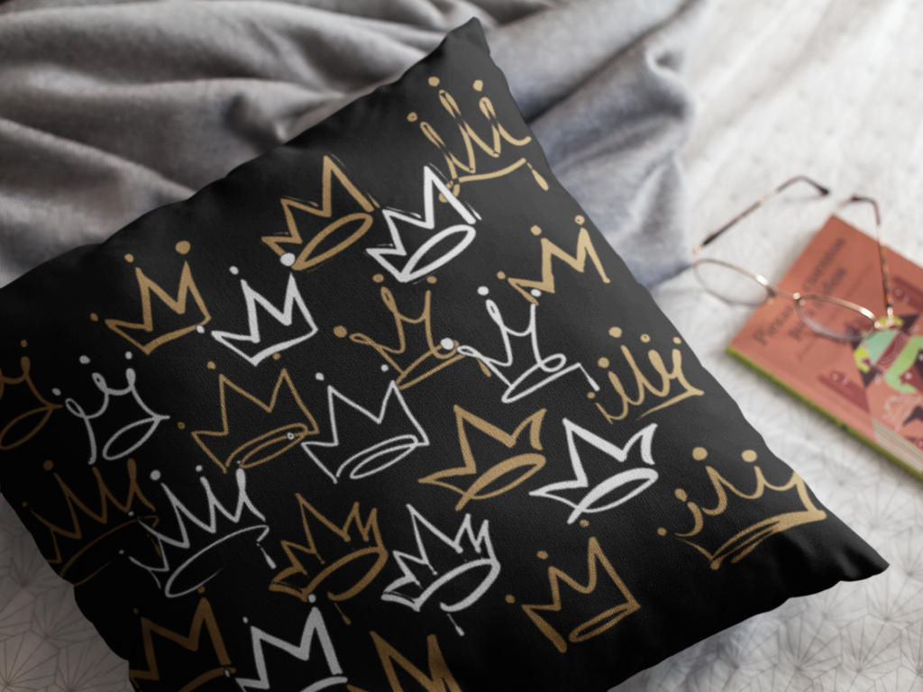 Black pillowcase with crown pattern on a bed
