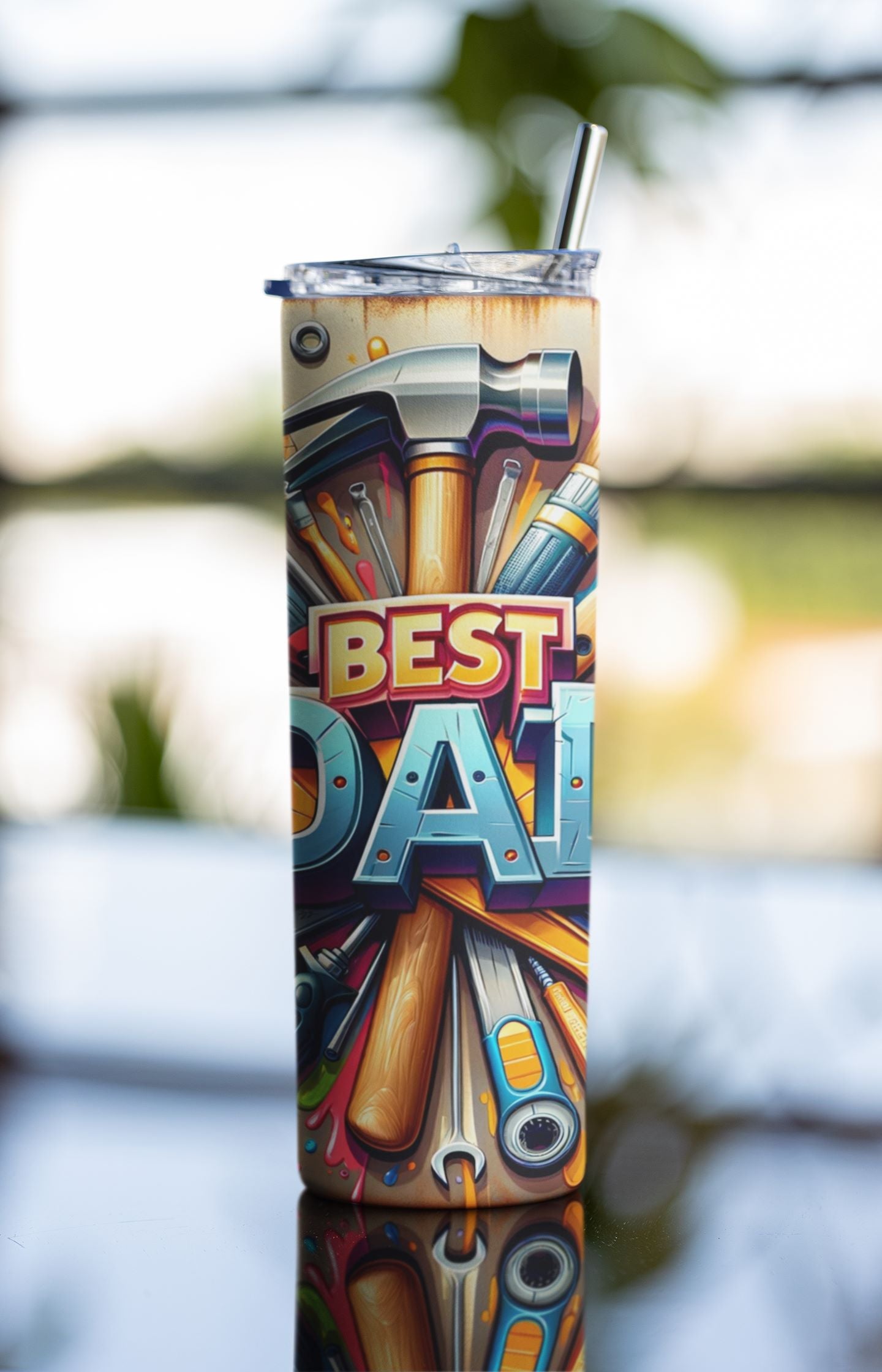 Tumbler with 'Best Dad' design featuring tools, outdoors.